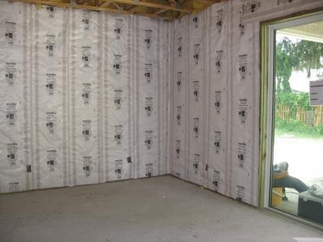 a room with a glass door and a wall covered in VR Plus shield insulation